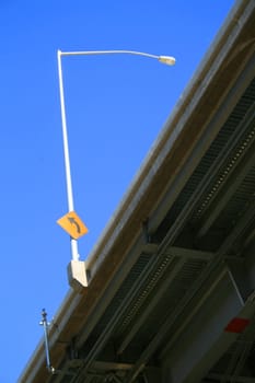 Close up of a traffic sign on a light pole.
