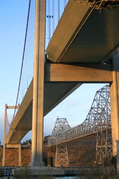 Two tall bridges built over a river.
