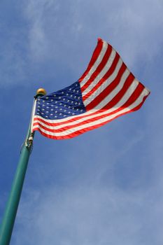 American flag over blue sky on a sunny day.
