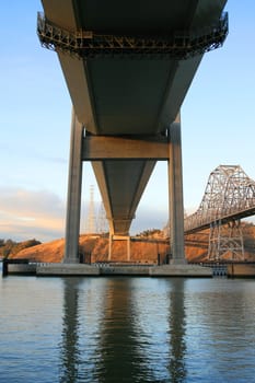 Two tall bridges built over a river.
