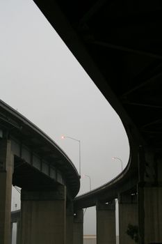 Close up of the empty freeway ramps in a fog.
