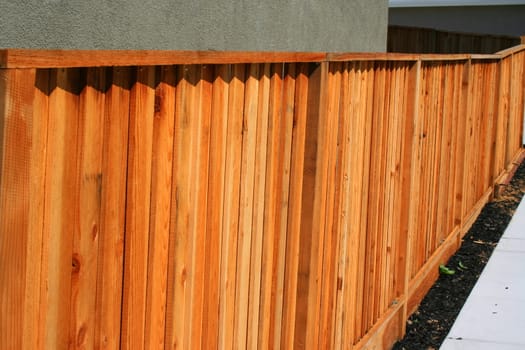 Wooden yard fence next to a house.
