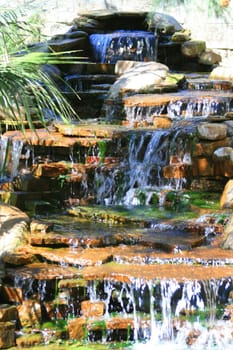 Close up of a waterfall in a garden.
