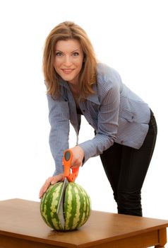 Beautiful young woman sawing the watermelon