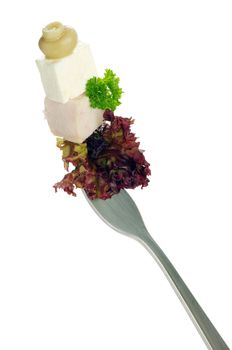 Fresh vegetables on a fork isolated on white background