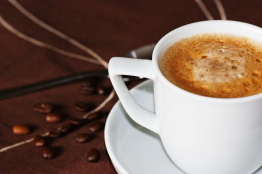 A cup of espresso coffee in a white cup and saucer