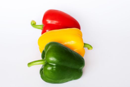 Red green and yellow peppers arranged like a traffic light
