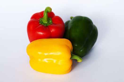 An arrangement of red green and yellow peppers