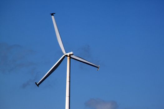 Windmill generating electricity for an industrial complex