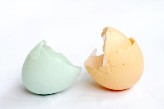 Broken empty eggshells on a white background