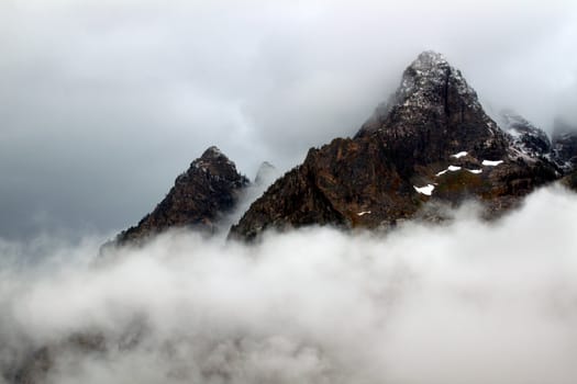 Dense clouds obscure jagged peaks of the Teton Range in western Wyoming
