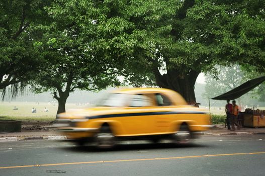 Motion blurred of old taxi in Calcutta (Kolkata), West Bengal, India.