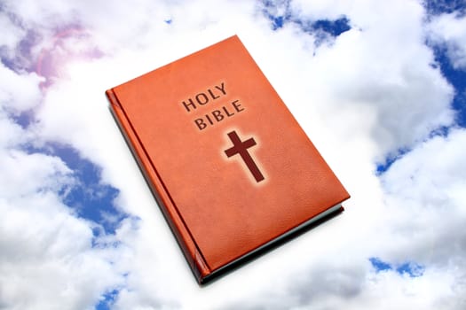 Bible in leather cover on background blue sky