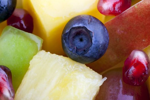 Close-up of blueberry with other fruit in fruit salad.