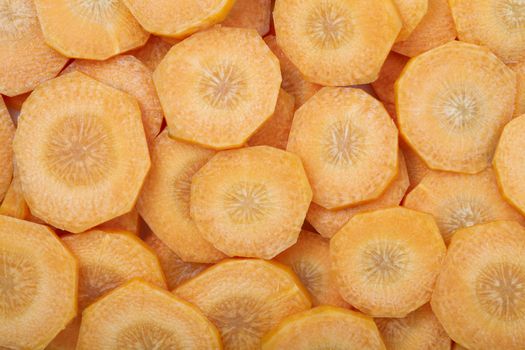 Slices of carrots filling frame making food background