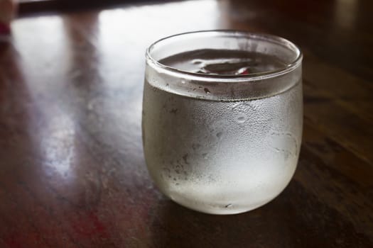 A glass of ice on the table