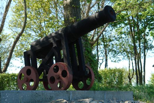 Old style vintage antique cannon on wheels                             