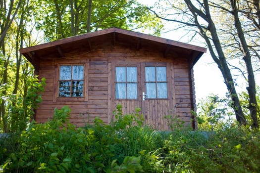 Classical design summer wooden cottage cabin in the middle of nature
