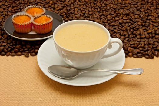 White cup of coffee and coffee beans