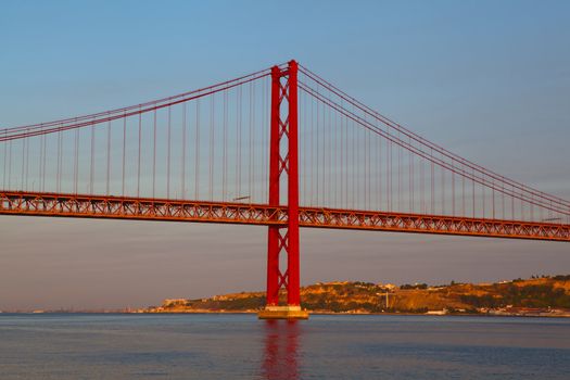 The 25 de Abril Bridge is a suspension bridge on river Tejo, Lisboa.