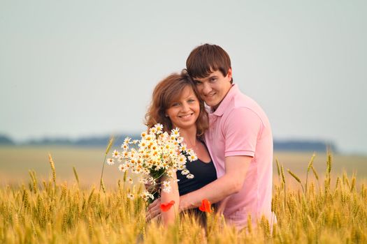 loving couple in a field of wheat