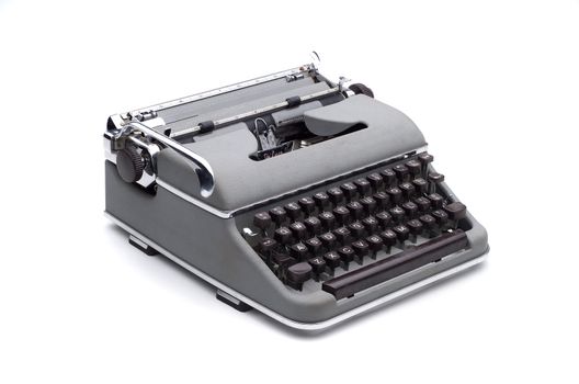 Gray vintage portable typewriter on white, isolated with clipping path