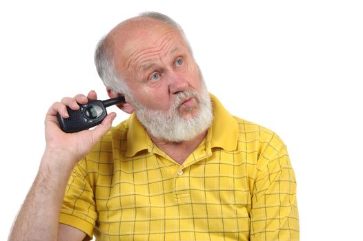 senior bald man picking his ear with walkie-talkie antenna