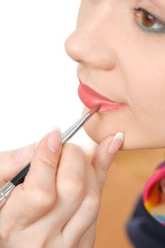 applying liquid glossy lipstick using special brush