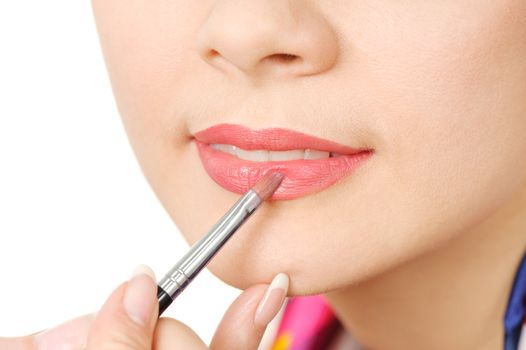 applying liquid glossy lipstick using special brush