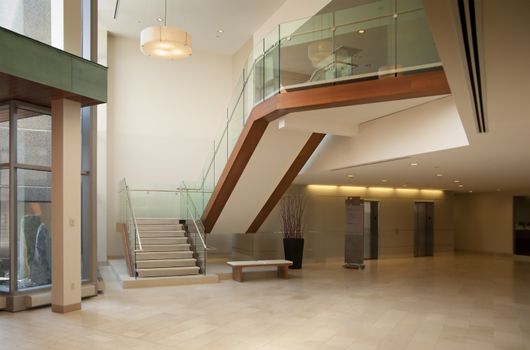 Modern office building lobby in marble, glass and mahogany