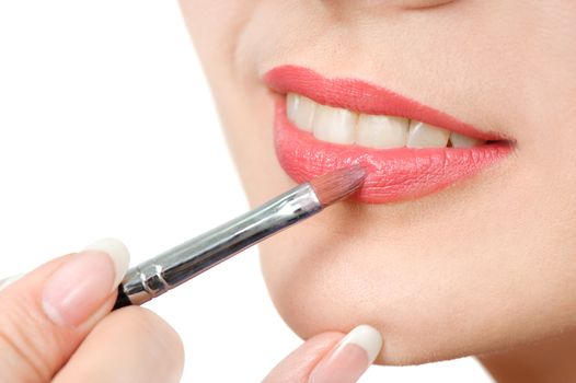 applying liquid glossy lipstick using special brush