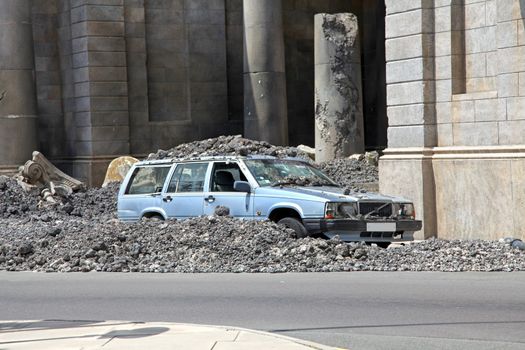 A car crashed in amongst concrete rubble