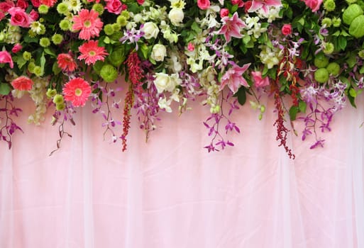 exotic flowers arrangement over pink fabric, flowers background.