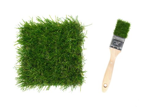 A close up image of artificle grass and a paint brush