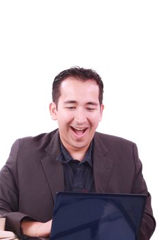 Happy young man working on laptop computer, having fun