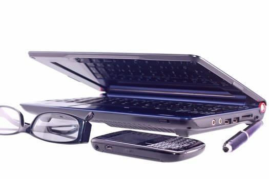 Cell phone, laptop, sunglasses and pen isolated