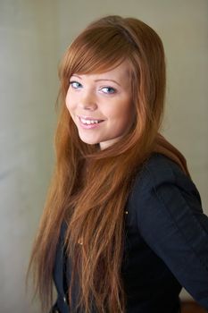 Teenage girl smiling, looking at camera, interior
