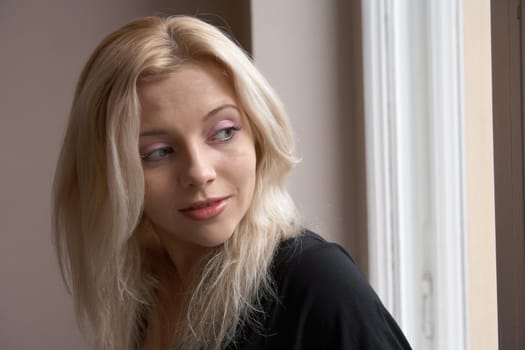 Young woman looking out window over shoulder