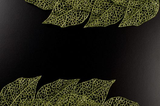 Green leaf frame forming an abstract frame over black background.