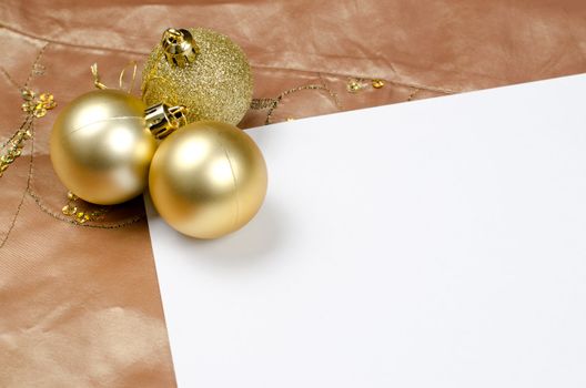 Gold christmas balls on a Christmas theme background.