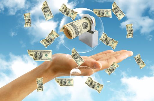 american dollar in hand on blue sky background