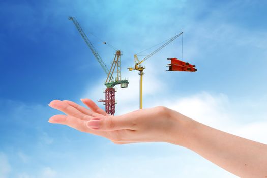Business   in construction crane area over blue sky