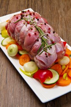 roast of beef with fresh vegetables ready to cook