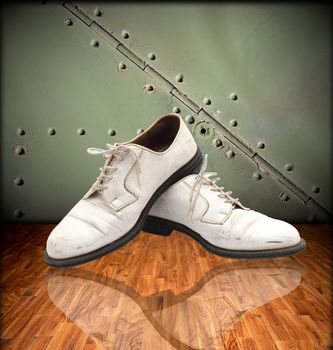 White leather shoes with a reflective surface in the room