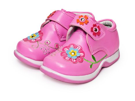 Shoes for little girls decorated with flowers isolated on white background