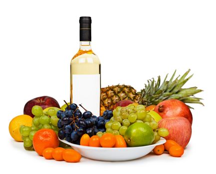 Still life - a bottle of white wine among tropical fruits isolated on a white background