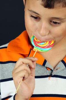Boy eating lollipop close up