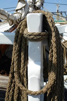  Nautical ropes hanged on a classical wooden sail boat yacht                             