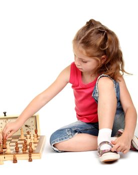 Little girl playing chess on the white background
