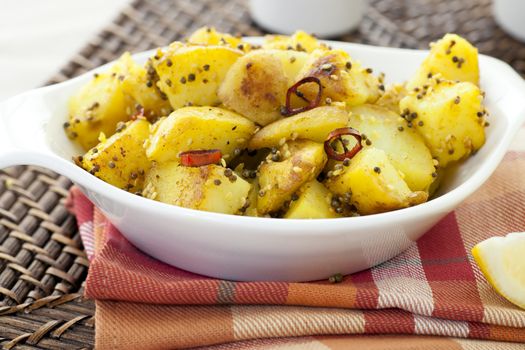 Spicy Potatoes with mustard seeds, sesame seeds, chili peppers and other spices.
